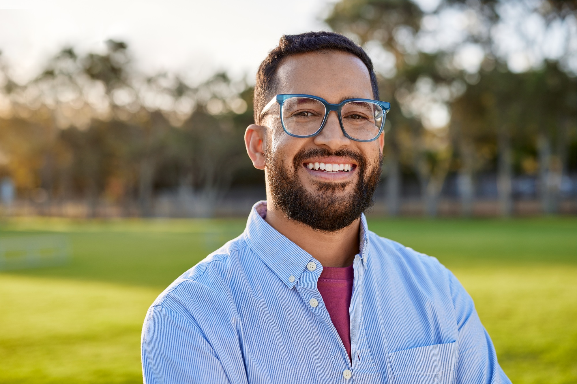 Portrait of happy mid adult man smiling at sunset